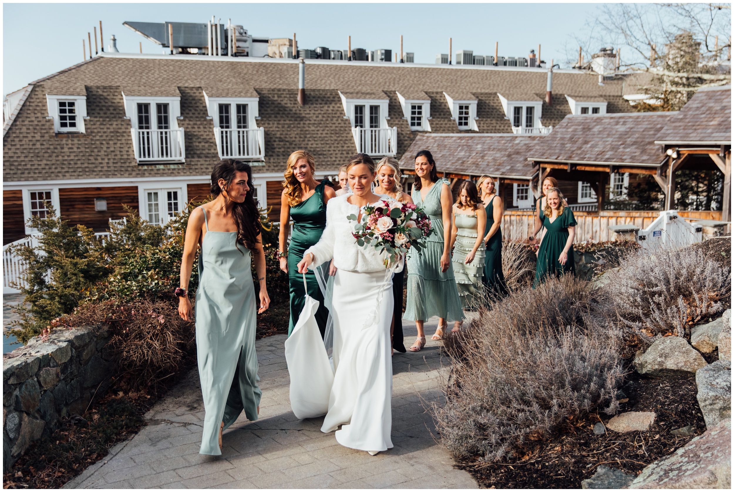 Bride walking with bridesmaids at winter wedding at Red Lion Inn in Cohasset MA